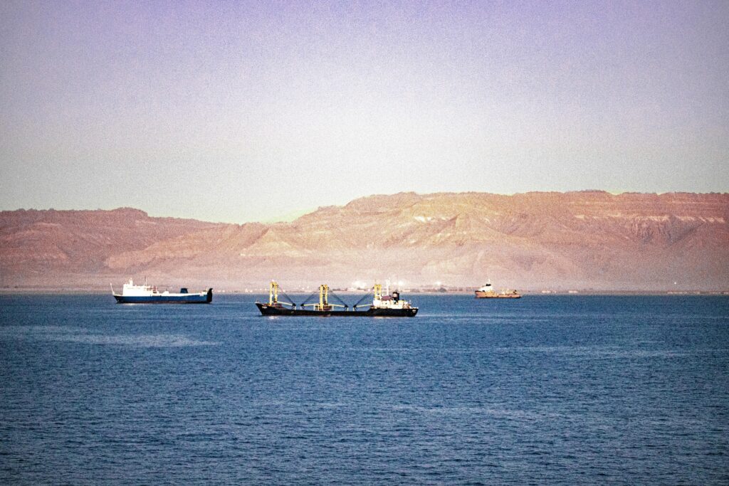 ocean freight container ships traveling through canal