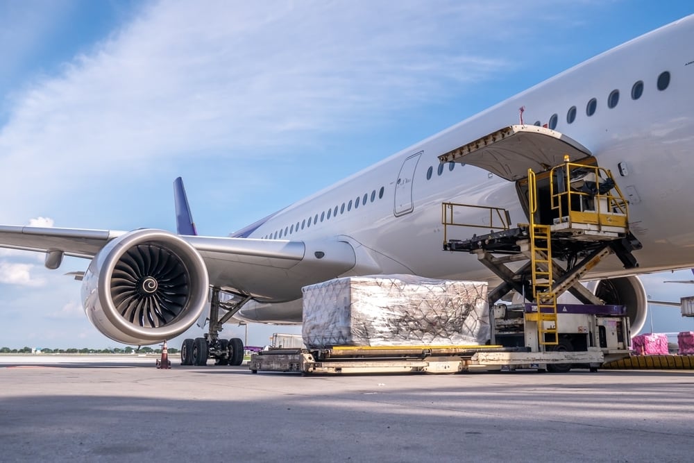 Air freight containers being loaded onto airplane