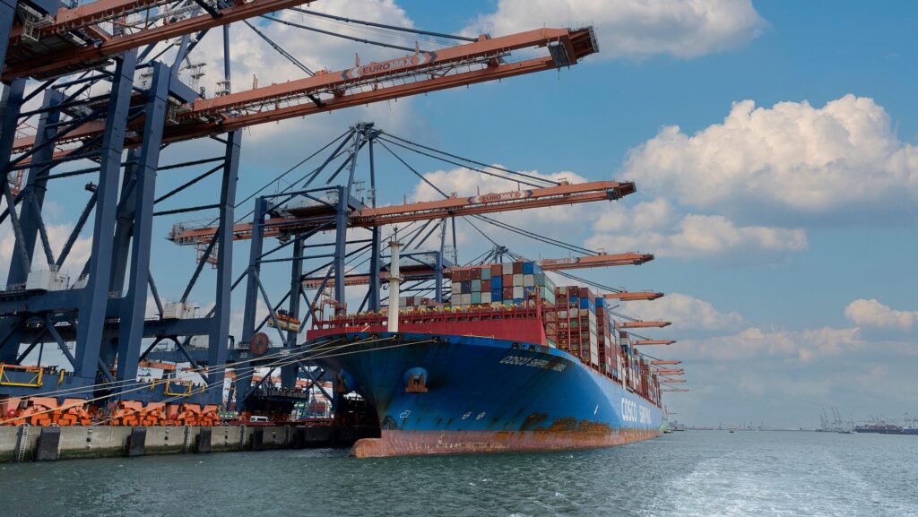 Large container ship docked at Euromax Terminal with cranes loading cargo at a busy shipping port.
