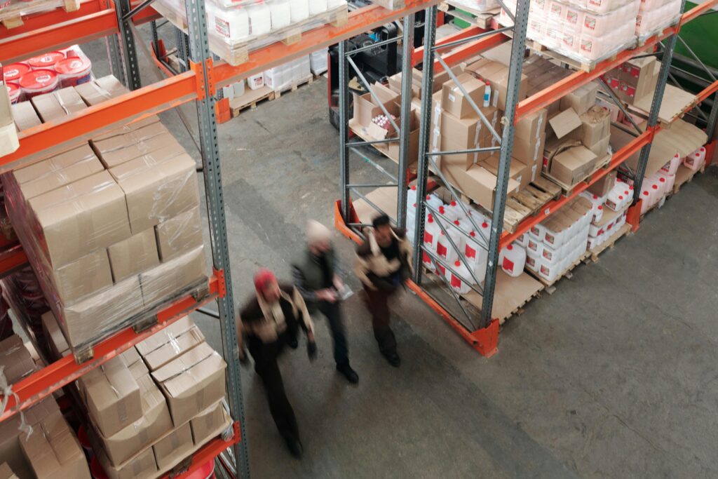 Seasonality and Surcharges: Importing Apparel from China in a Volatile Market 3 Warehouse workers moving inventory in distribution center during peak back-to-school shipping season