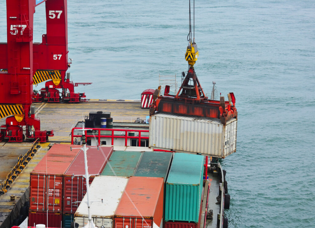 Cranes unloading shipping containers at a port. 