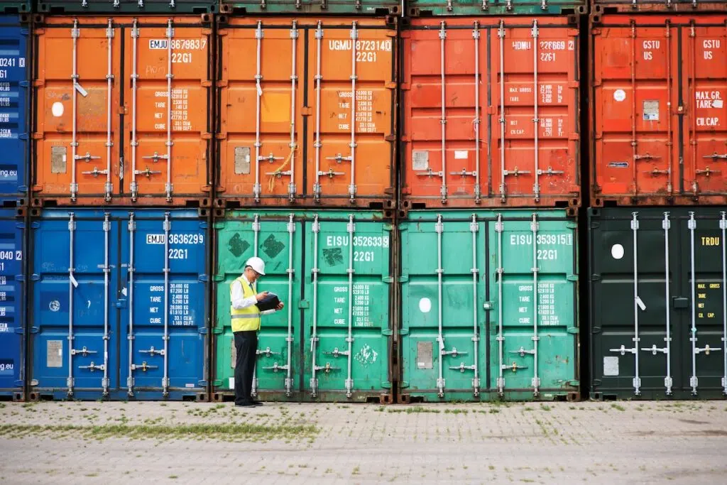Customs officer inspecting shipping containers at a US port terminal