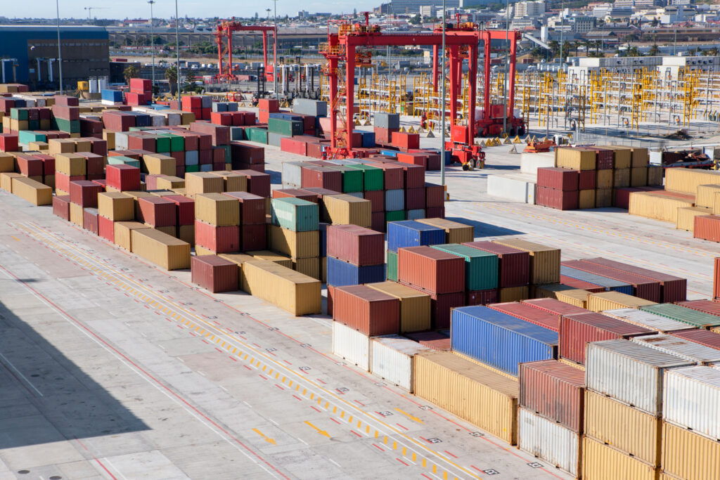 Cargo containers waiting to be loaded at a shipping yard.