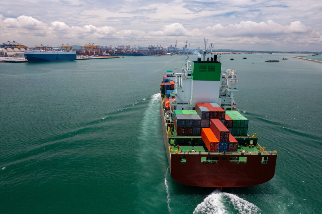 Cargo ship loaded with containers entering a port.